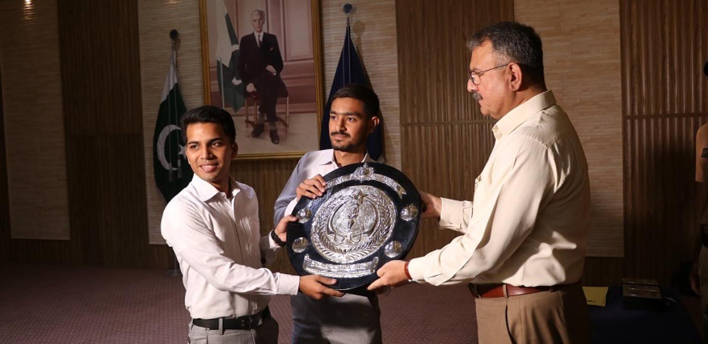 Principal is awarding discipline trophy to Ayub House cadets