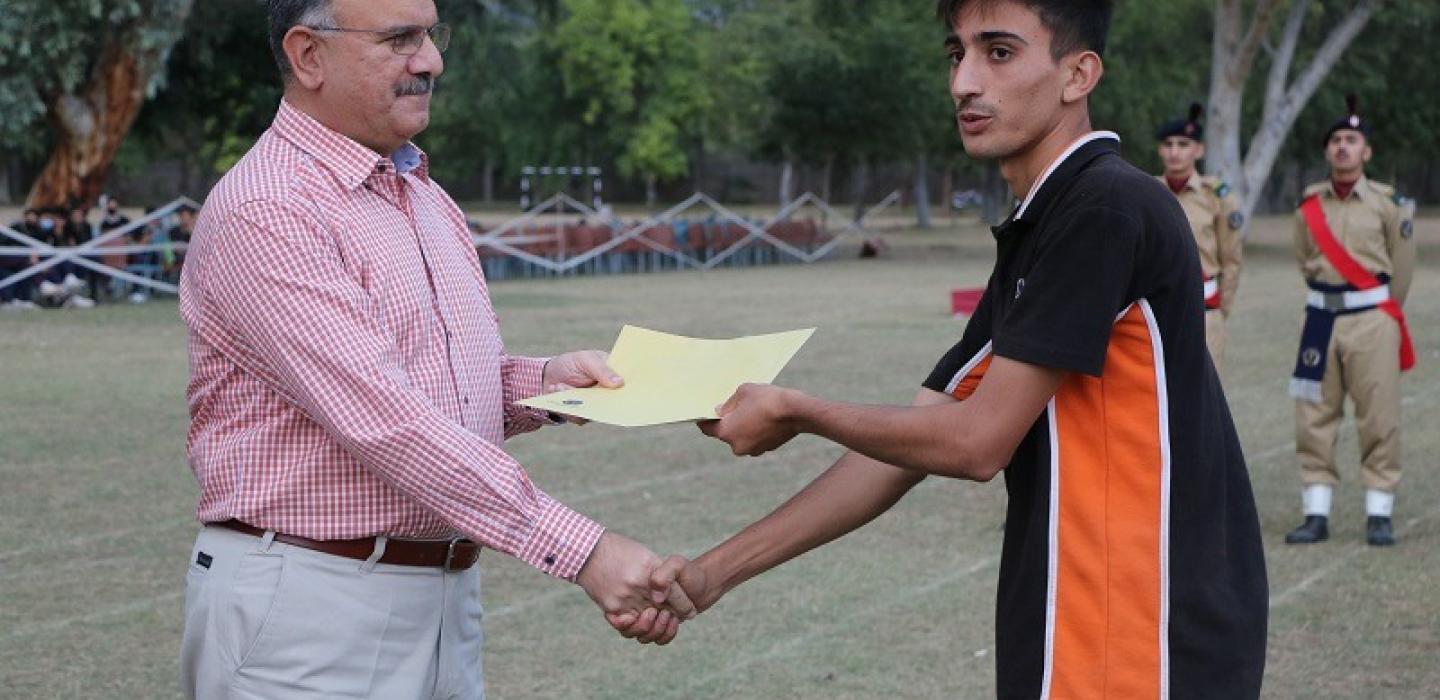 Principal is awarding certificate to a cadet